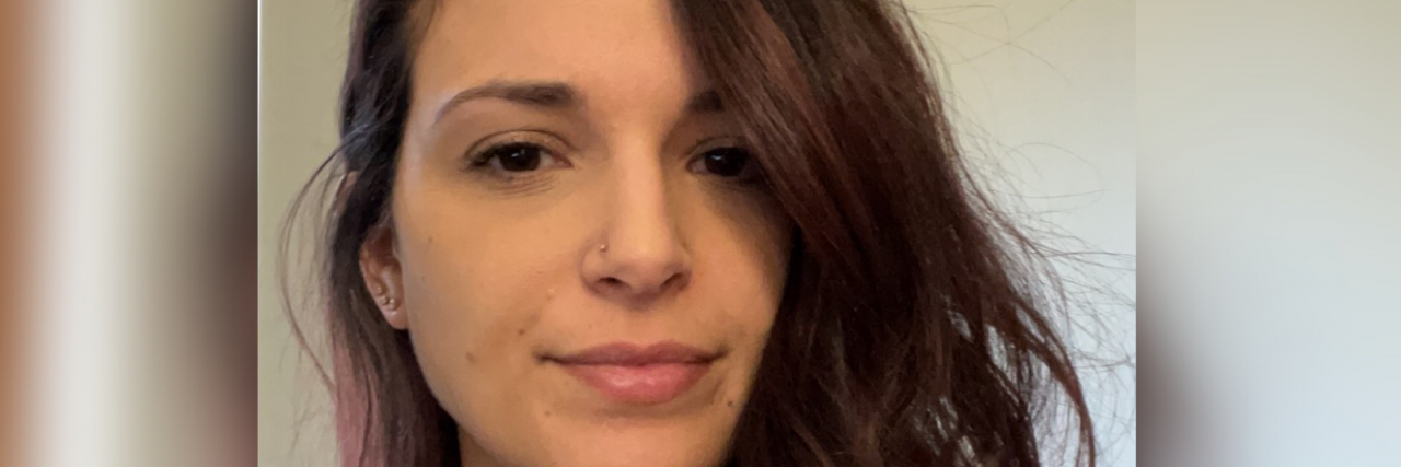 What Helps a Woman in Her Thirties With Multiple Sclerosis Close-up photo of a white woman with brown eyes and long brown hair.