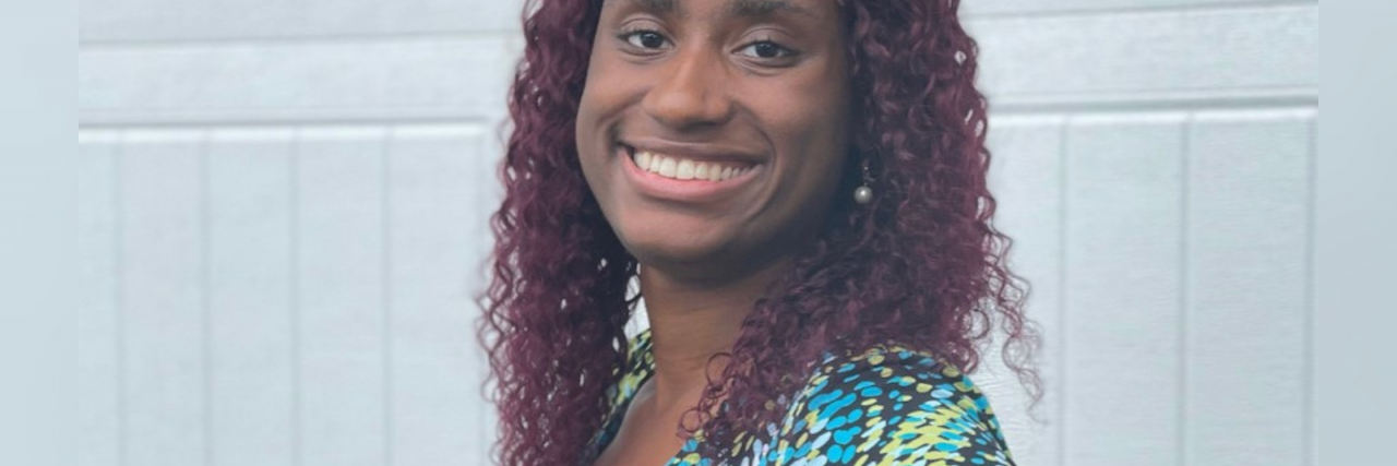 What Helps a Woman in Her Twenties With Generalized Anxiety Disorder Fairley, an African-American woman, faces the camera wearing a blue patterned dress and posing with her hand on her hip.
