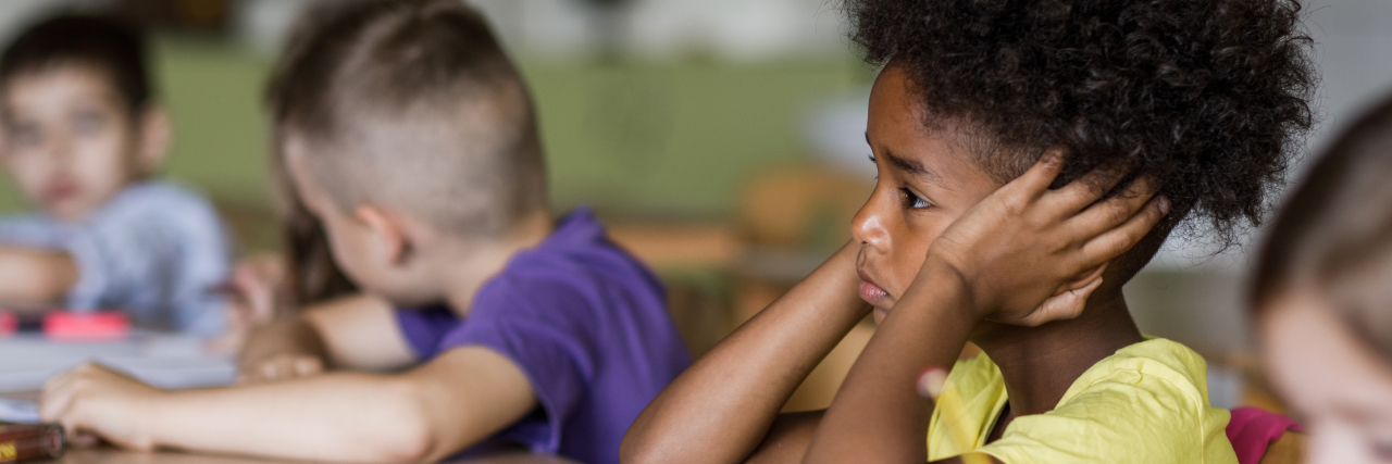 Early Signs of Growth Hormone Deficiency in Children Parents Shouldn't Ignore Sad Black child in classroom.