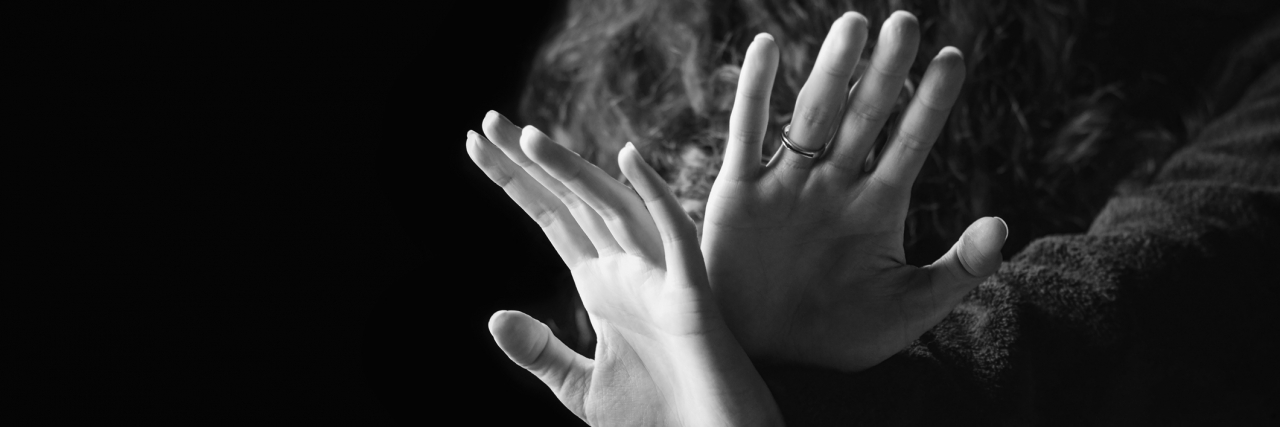 A Poem About Coping With Distress and Fear A woman holding her hands up