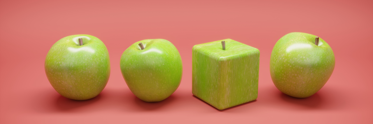 Cube shaped apple between the round apples