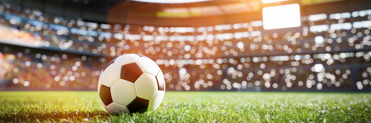 Realizing I Wasn't Alone After My Autism Diagnosis Football soccer ball on grass field in stadium.