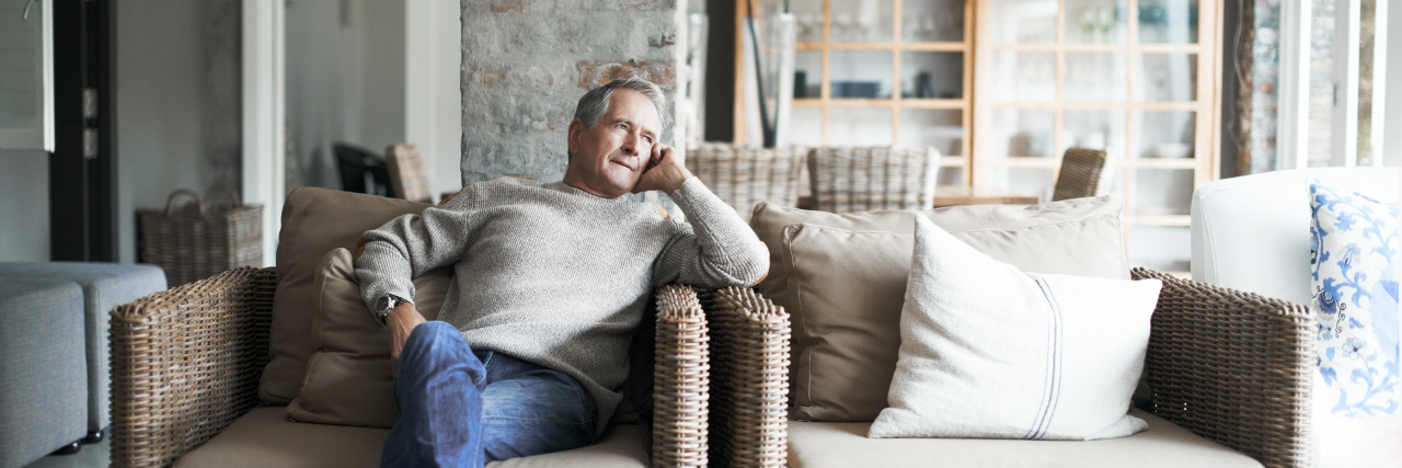 Man sitting in chair thinking.