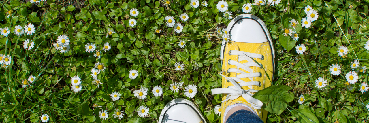 I Don't Judge My Sensory Processing Disorder Yellow sneakers in a daisy field.