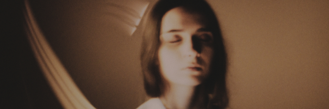 New Peer Support Line for People Trying Therapeutic Psychedelics Young woman with eyes closed and light auras around her