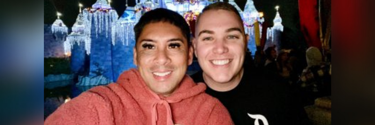 3 Ways to Practice Self-Love This Valentine’s Day — Single or Not! Author and his partner taking a selfie in front of the Disneyland castle, smiling