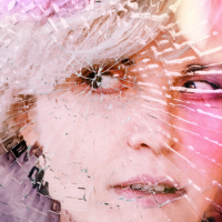 View of woman's face as if behind cracked glass