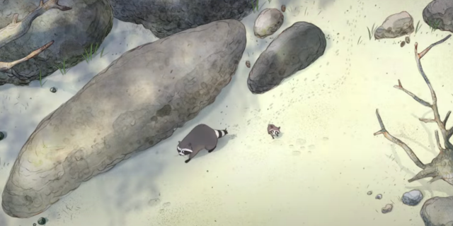 A still from "Far From The Tree," a new Disney+ short. Its an aerial view of two raccoons (one larger, one smaller) on the beach next to some rocks.