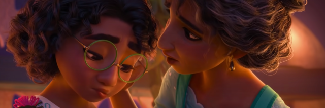 A still from Disney's "Encanto" where Mirabel, a young colombian girl is being tended to by her mother. Mirabel looks sad and her mother is comforting.