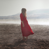 A woman standing in a field of dirt