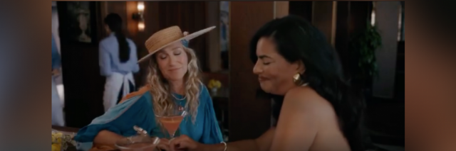 Image of Carrie and Seema from "And Just Like That..." sitting together to have a drink