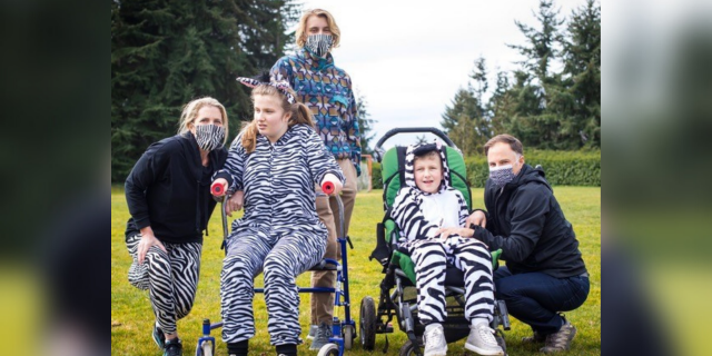 The Hawkins family wearing matching zebra outfits on Rare Disease Day.
