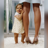 Toddler girl hugging her mom's leg. Mom is wearing high heeled shoes.