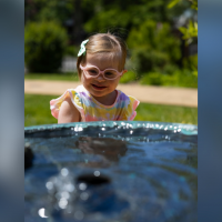 Nicole's preschool daughter who has Down syndrome looking into a pool.