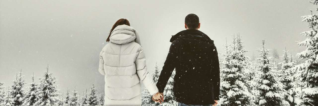 When PTSD Makes You Fear Healthy Romantic Relationships Back of a man and woman in winter jackets holding hands