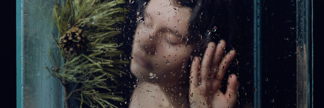 Dissociation Trend on TikTok: What to Know About 'Reality Shifting' photo of a person surrounded by a clear box with a tree in the middle