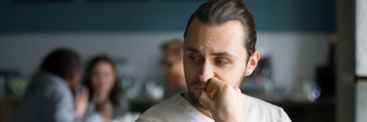 21 Quotes Everyone Should Read Before Judging Someone Facing Addiction Guy sitting in a cafe with others blurred behind him