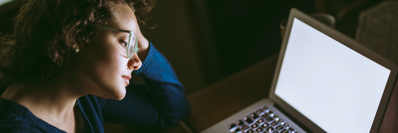 Misleading Information and Complex Regional Pain Syndrome (CRPS) Woman looking at computer in the dark