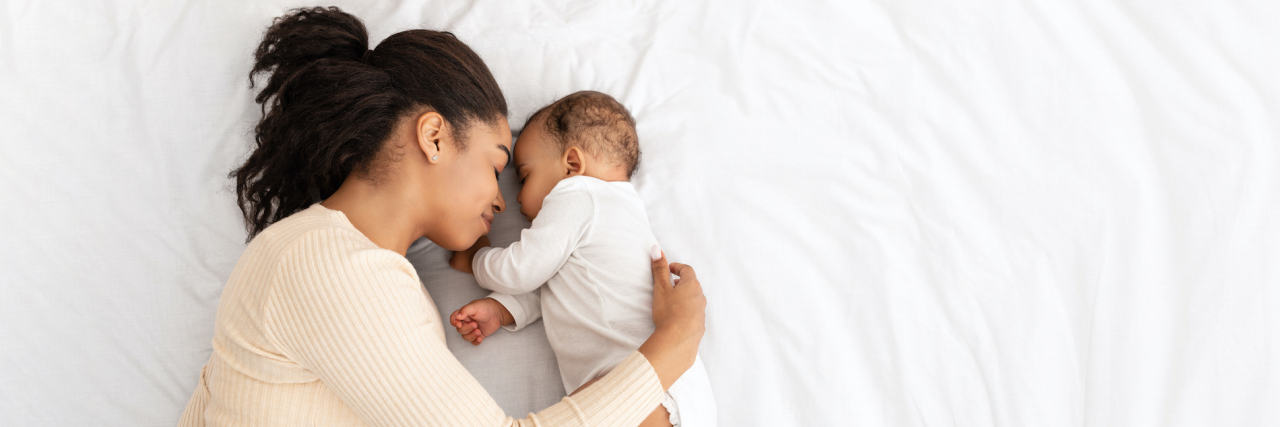 I Chose Donor Insemination as a Single Mother to Have a Baby Black mother hugging baby on bed
