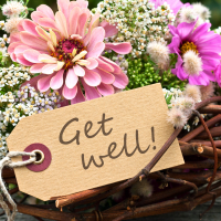 pink flowers and card with lettering "get well"