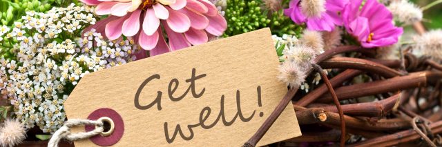 pink flowers and card with lettering "get well"