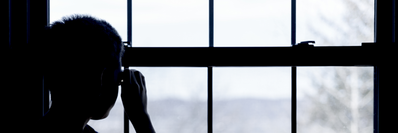 Chronically Ill People, Stop Accusing Others of Faking Their Illnesses Person looking out window.