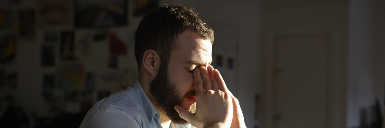 Today I’m Done Being the Inspirational Chronic Illness Warrior Sad man sitting at kitchen table.