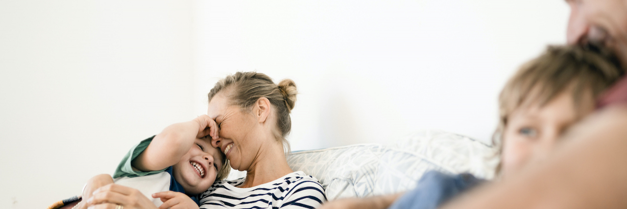 Pediatric Growth Hormone Deficiency Treatment Options: What Families Need to Know Mother and father snuggling on couch with their two sons