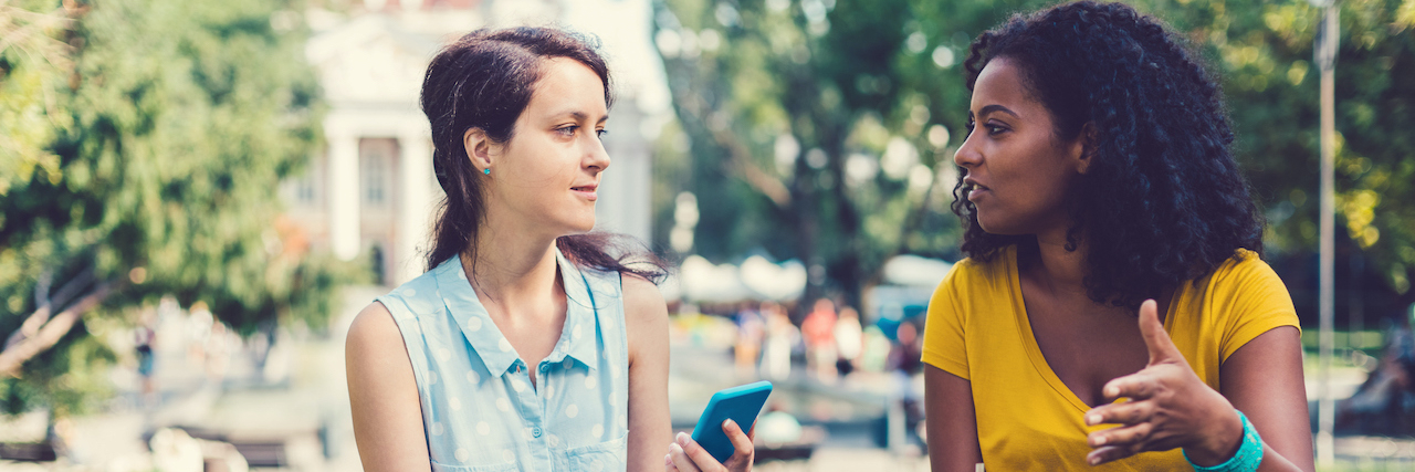 A Stranger's Kindness When I Felt Entirely Alone With Trauma A white woman and Black woman in the park drinking coffee and talking