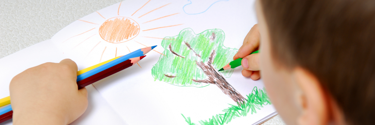 Art Was My Voice When I Couldn't Speak as a Child With Autism Boy drawing a tree.