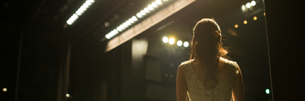 Why I Have to Keep My Chronic Illness a Secret to Keep My Career Woman backstage.