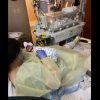 A mother is lying in a hospital bed holding her newborn baby.