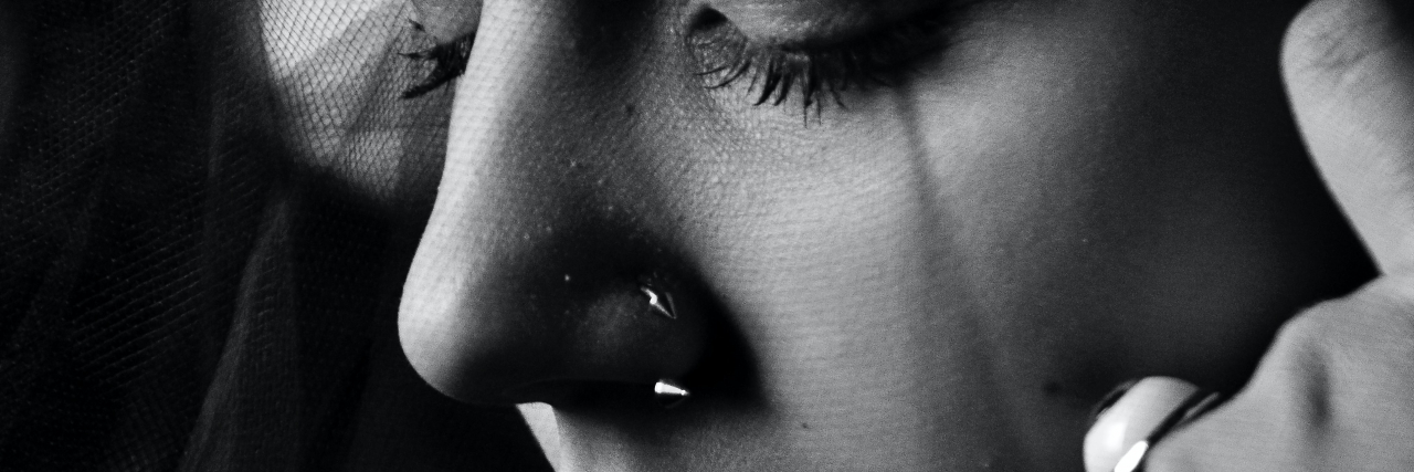 black and white close up photo of a woman's tears and lower face