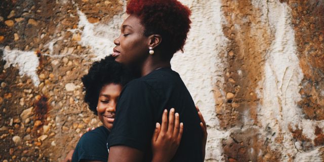 Why This Eating Disorder Support Group for Only Black People Saved Me photo of two Black women embracing in front of a wall