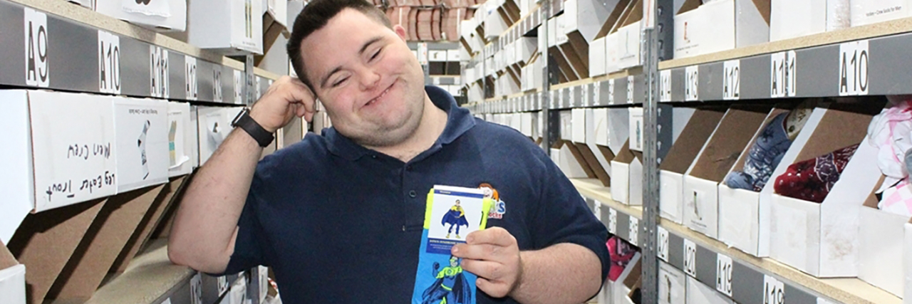 Hiring People With Disabilities Is Not Altruism, It Is Good Business John holding a pair of his crazy socks.