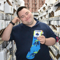 John holding a pair of his crazy socks.