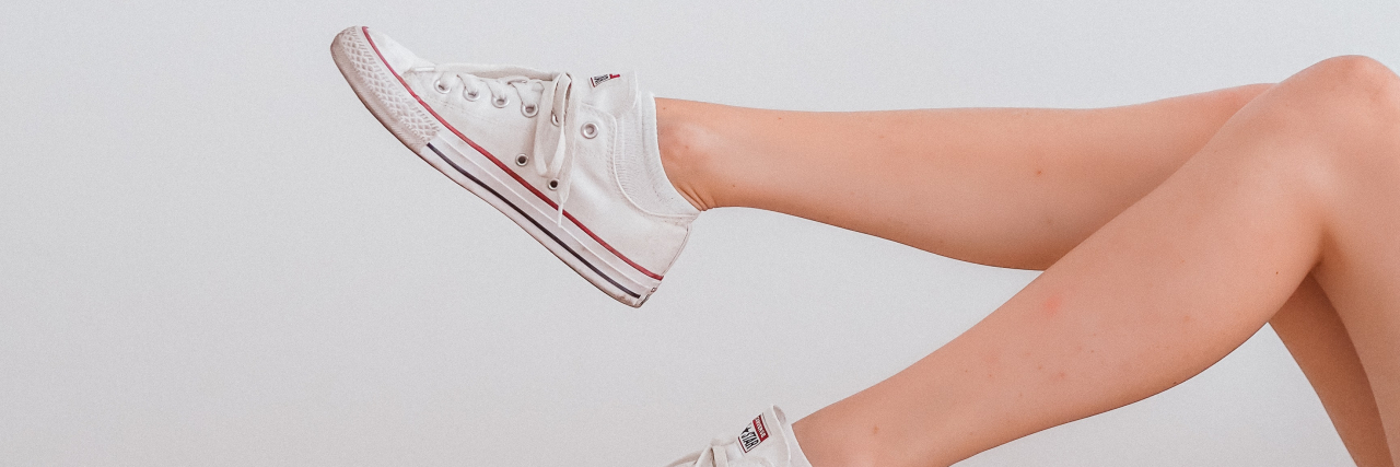 Using Physical Therapy to Treat Weak Muscles Because of Depression photo of a person's legs in white sneakers against a white wall