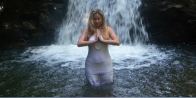 To the Newly Diagnosed Ehlers-Danlos Syndrome Warrior Contributor standing in front of waterfall holding her hands in prayer position