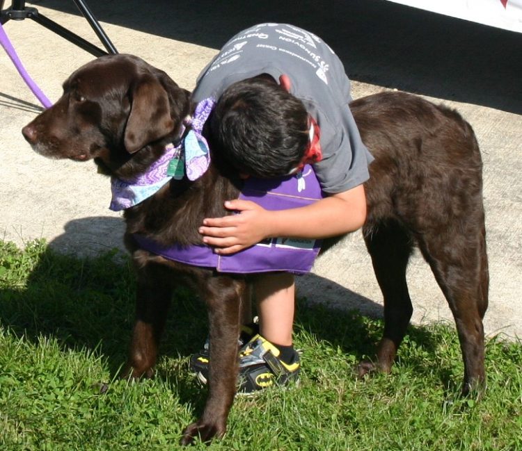 Ruby getting a hug from a boy.