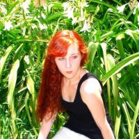 Amelia as a teen, sitting in a field.