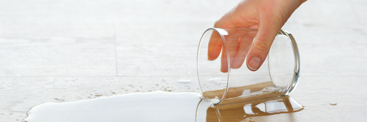 How My Nonverbal Learning Disability Affects My Coordination Woman picking up a drinking glass of water spilled on the floor.