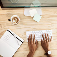 Person working at a desk with to-do list.