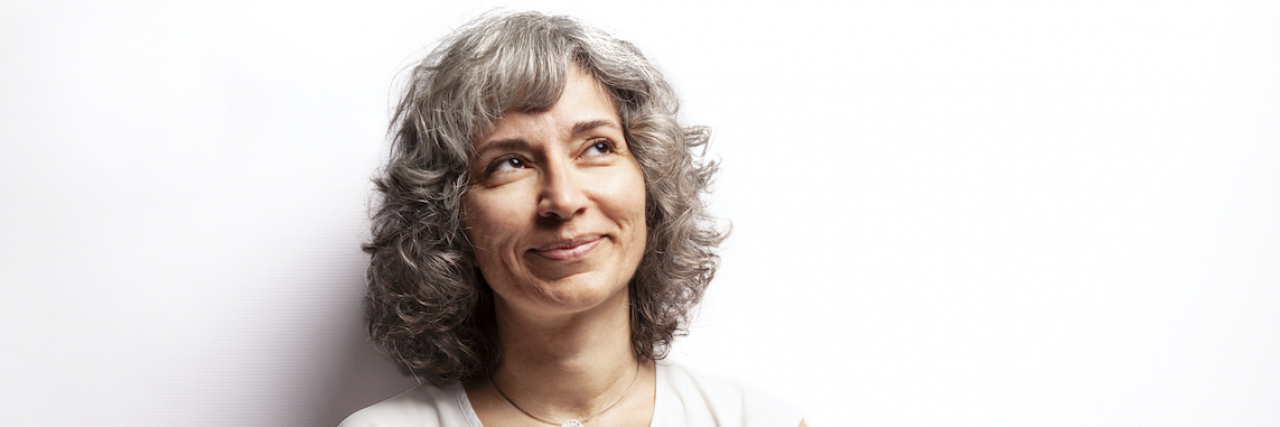 Figuring Out What Caused My Inflammation and Improving My Chronic Pain Mature woman looking to the side with arms crossed