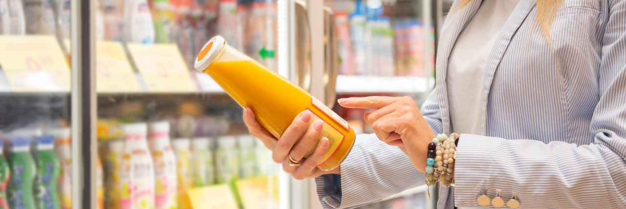 9 Things Not to Feel Guilty About Doing When You Have Allergies Woman with allergies reading ingredients on bottle.