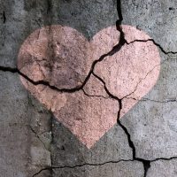 Drawing of a heart on a cracked wall.