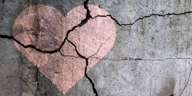 Remembering All the Times I Thought About Leaving You Drawing of a heart on a cracked wall.