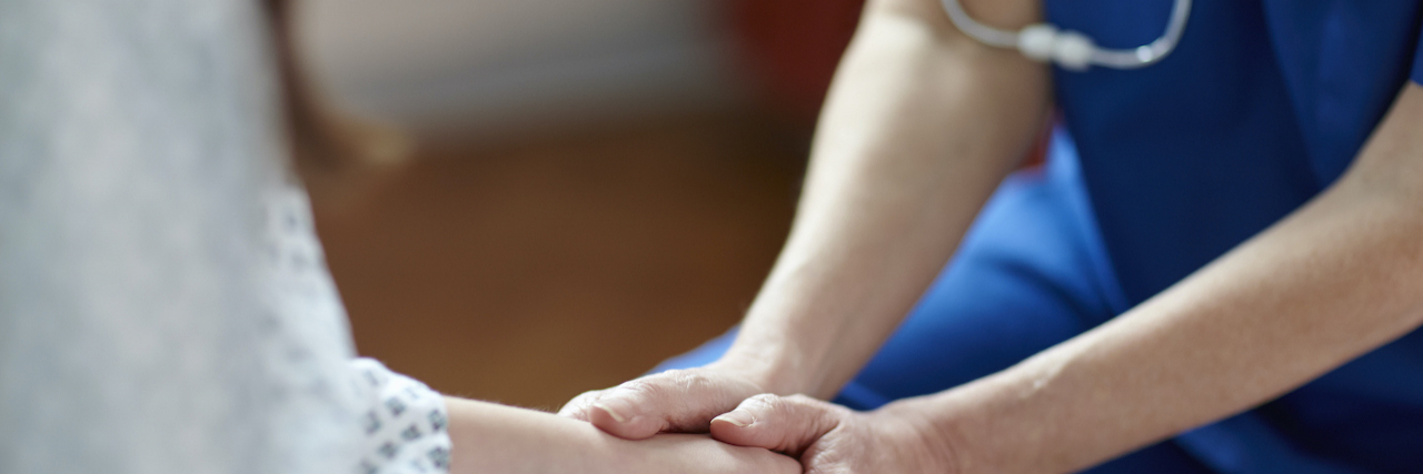 Gynecological Procedures When You Have a History of Sexual Assault Nurse holding patient's hand