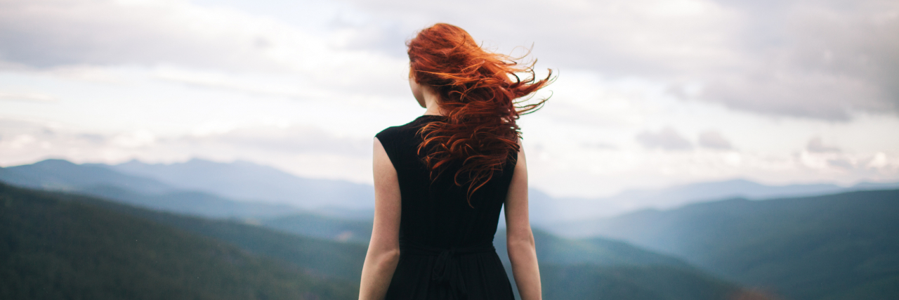 Bipolar Disorder: 5 Things I've Lost Due to Mental Illness Back of a woman in a black dress standing on a mountain