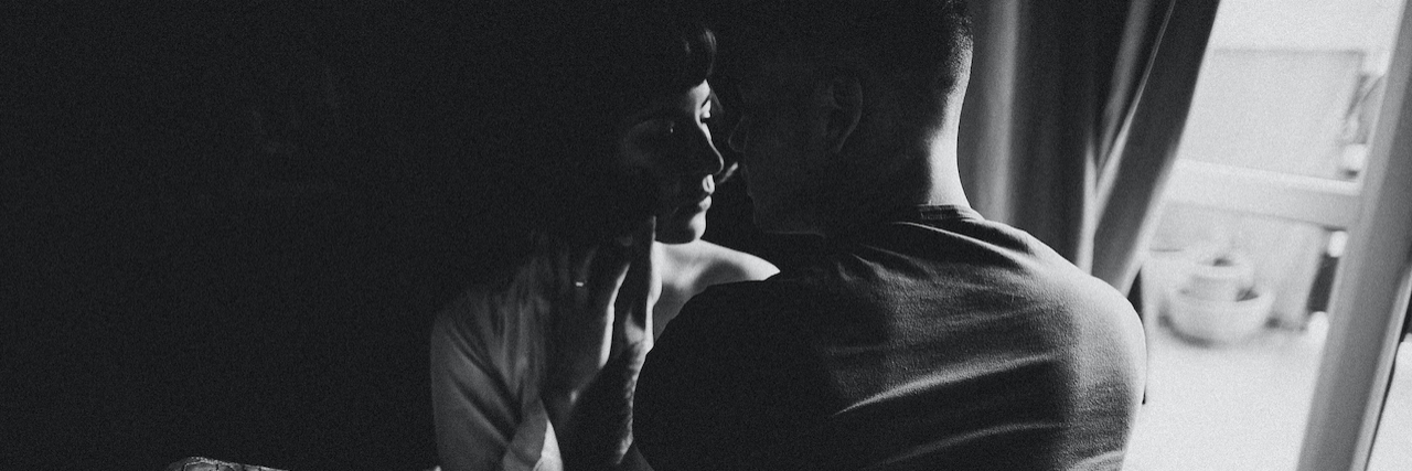 Navigating OCD When You're Having Sex Black and white photo of couple sitting on bed with faces close together