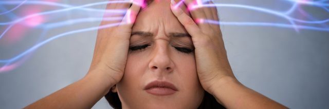 Stressed woman with lights emanating from her head.
